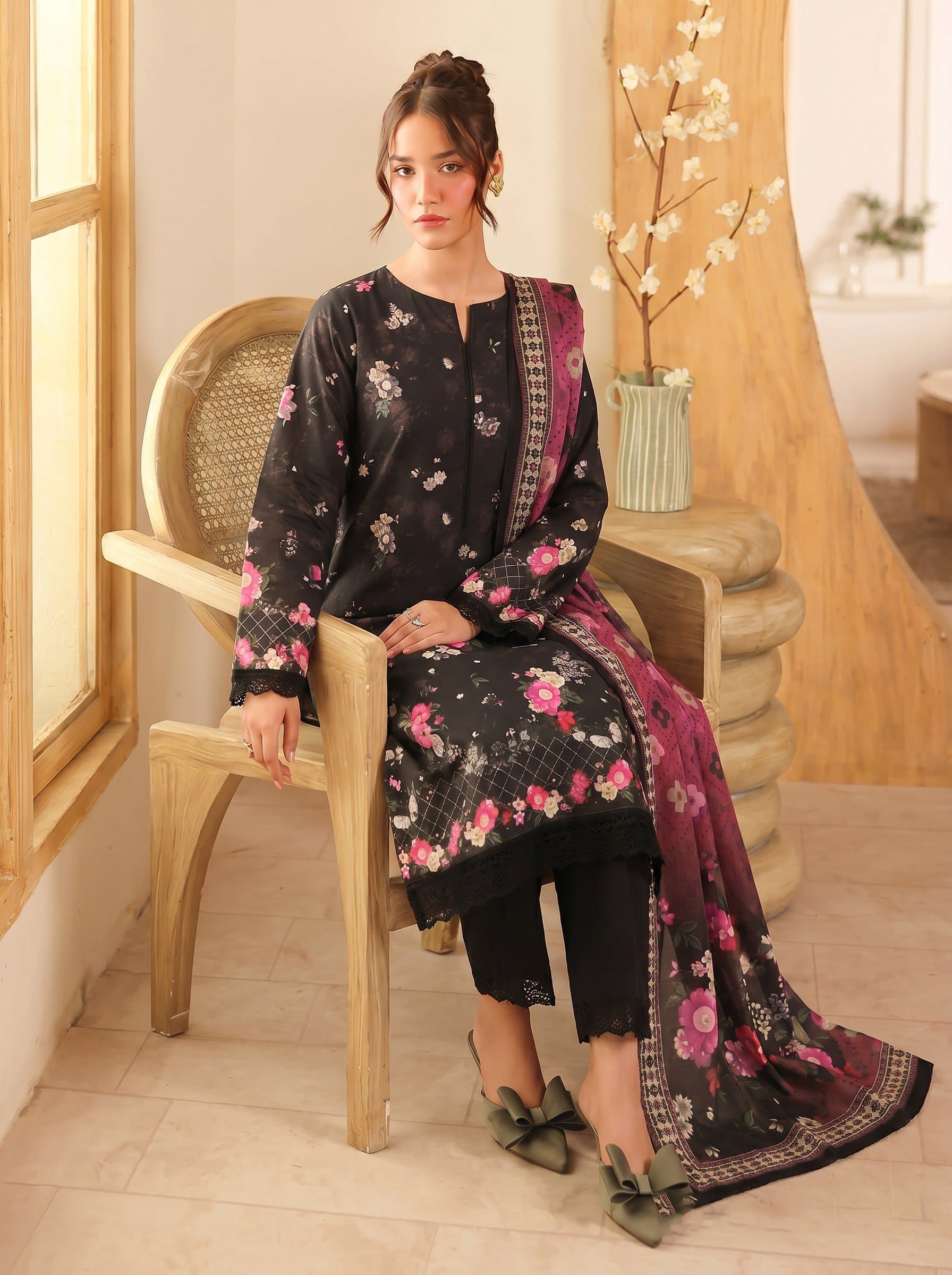 Model wearing a black and pink floral-print unstitched lawn suit — signature prints lifestyle shot